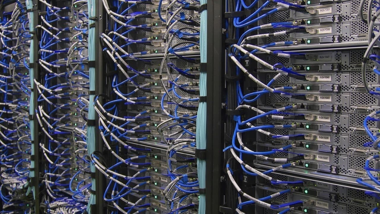Rows of server racks and cabling inside a data center.