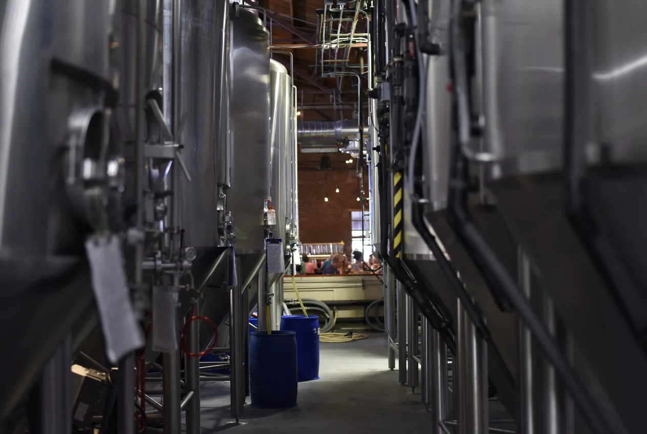 Stainless process tanks on a production floor